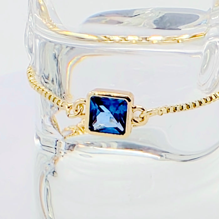 18k Gold Penis Noose Bracelet with Bright Blue Gem.