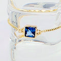 18k Gold Penis Noose Bracelet with Bright Blue Gem.