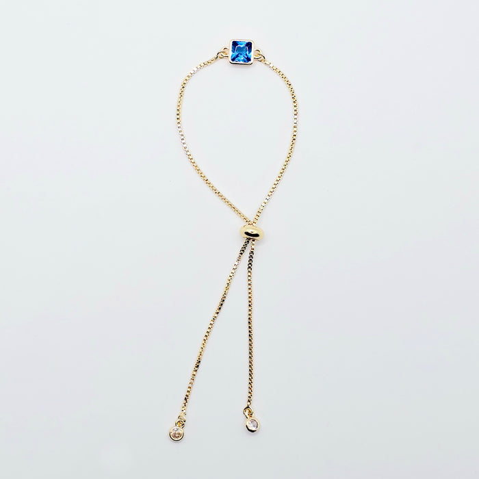 18k Gold Penis Noose Bracelet with Bright Blue Gem.