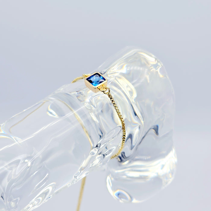 18k Gold Penis Noose Bracelet with Bright Blue Gem.