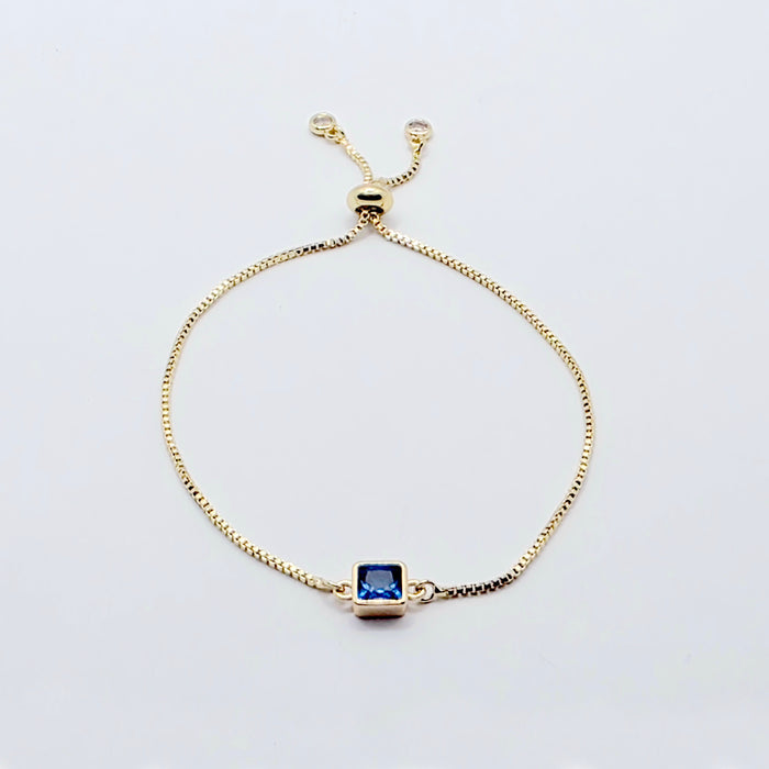 18k Gold Penis Noose Bracelet with Bright Blue Gem.