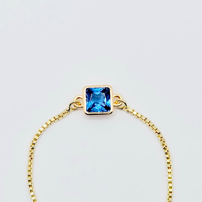 18k Gold Penis Noose Bracelet with Bright Blue Gem.