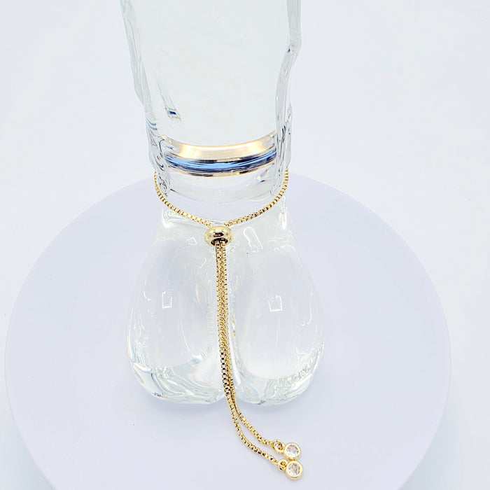 18k Gold Penis Noose Bracelet with Bright Blue Gem.