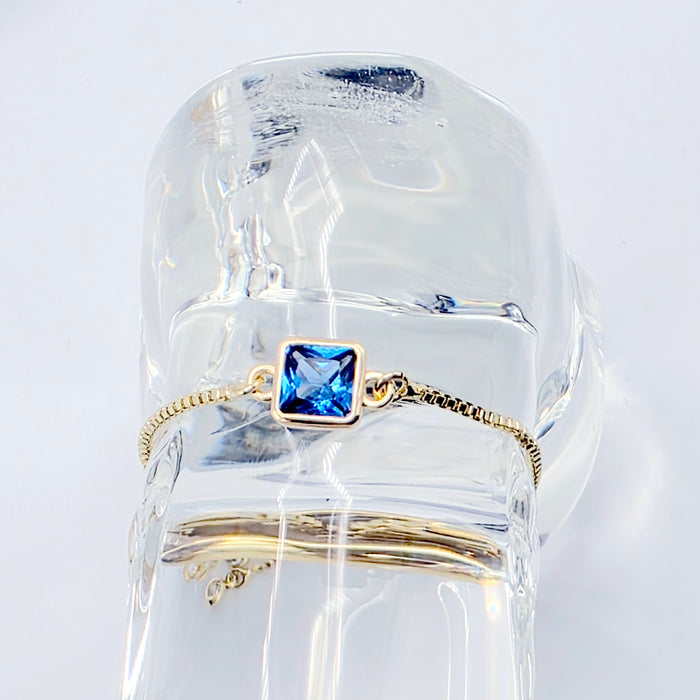 18k Gold Penis Noose Bracelet with Bright Blue Gem.