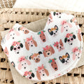 White baby bib with a fun dog print—featuring cartoon-style puppies wearing flower crowns, bows, and sunglasses. Absorbent terry towelling backing, ideal for teething and feeding.