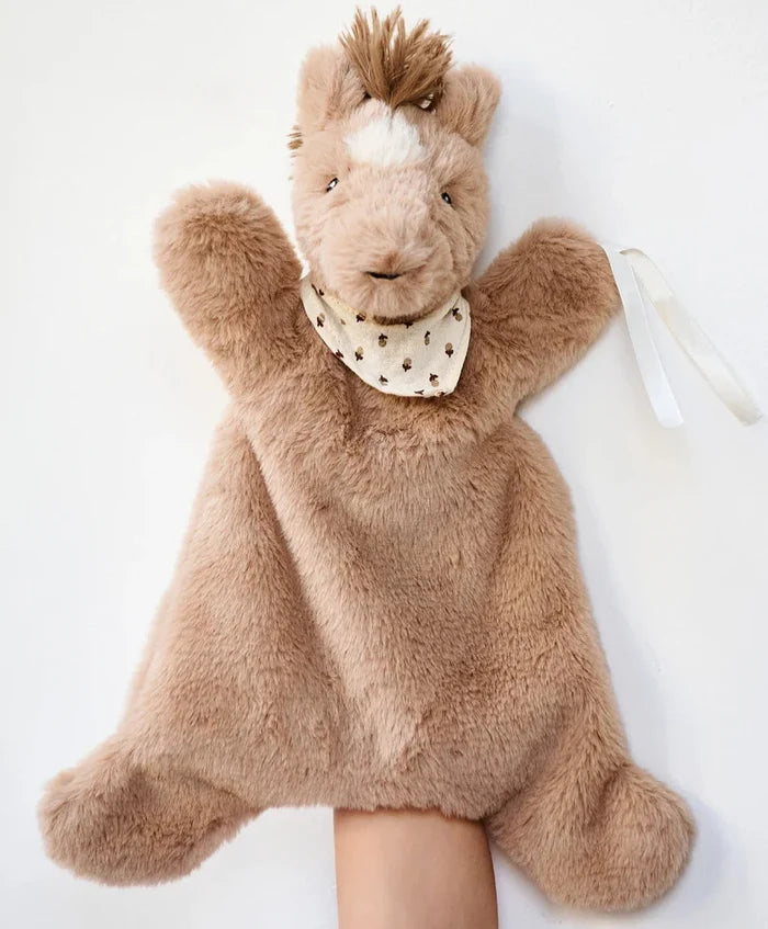 A plush toy resembling a horse with a humane face, wearing a beige bib scattered with tiny little acorns, designed to be used as a baby sleep aid and hand puppet.