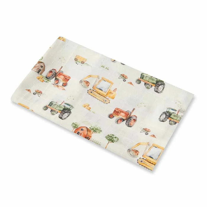 Baby muslin wrap with construction vehicle pattern on a white background