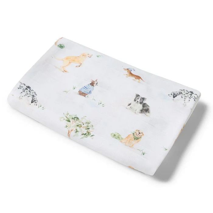 Muslin swaddle with different breeds of puppy dog drawings on it.
