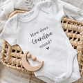 Baby announcement onesie with the text how does Grandma sound? on it in black