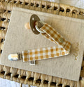 Handmade vibrant mustard and cream gingham check dummy clip with metal clasp.